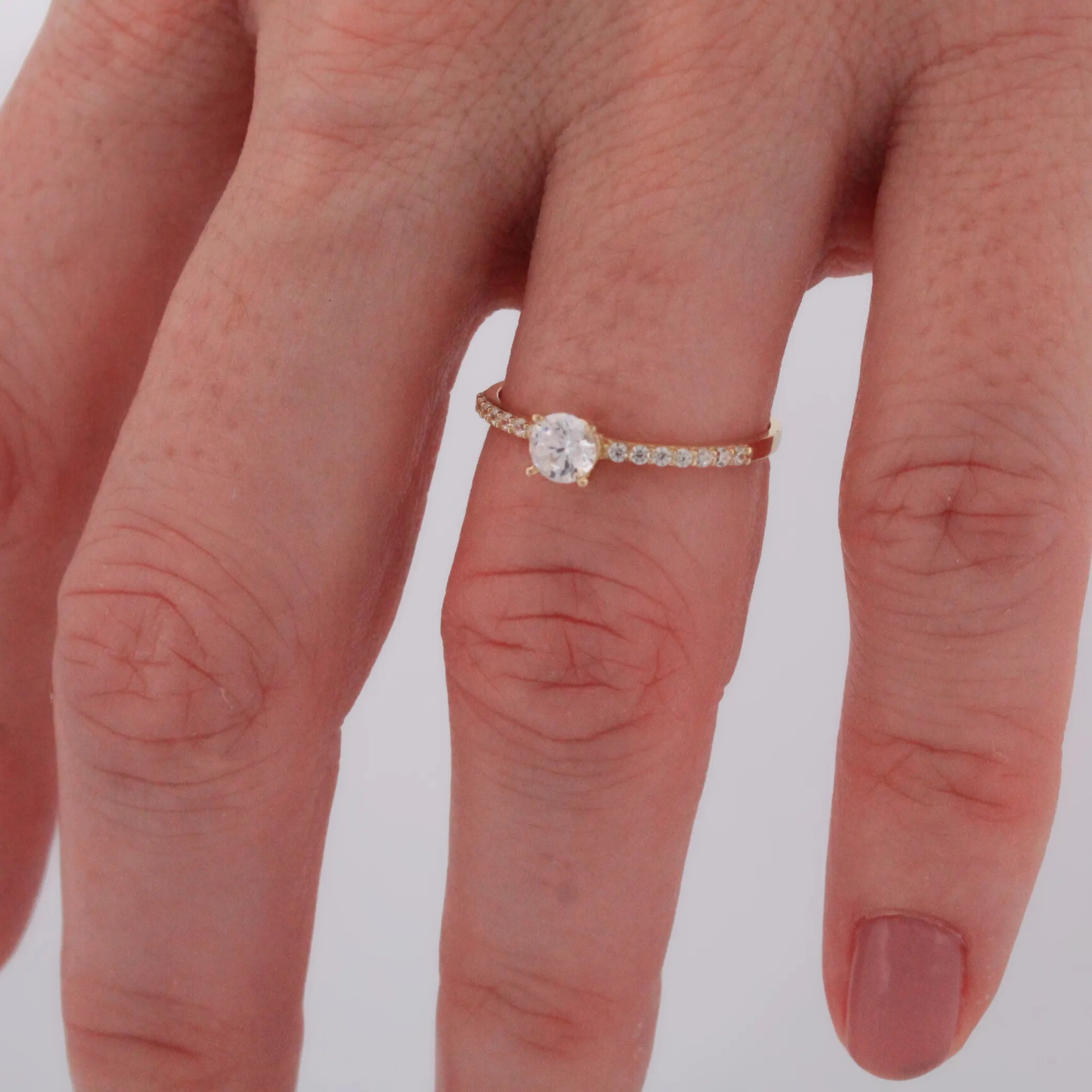 Jemný zlatý prsteň STELLA so zirkónom nasadený na prstenníku, lifestyle záber.